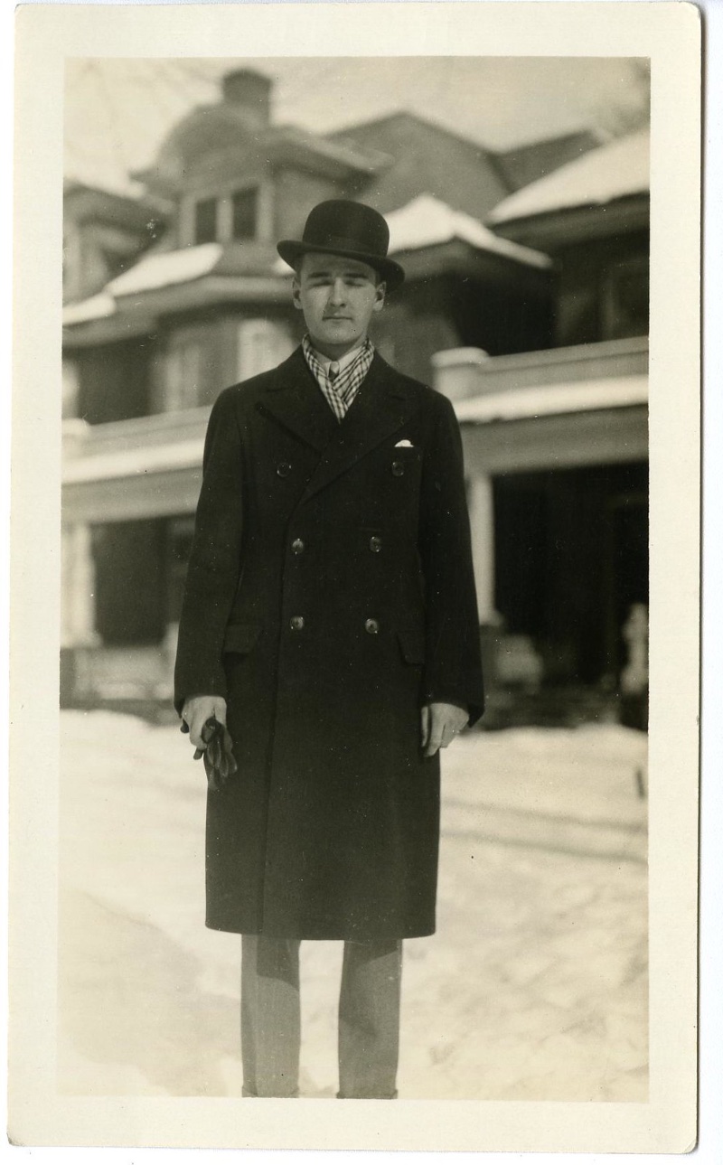 1920s Mens Fashion Double breasted Coat Bowler Hat Photographed in the 1920s, a slender man poses in a double-breasted coat and bowler hat.
