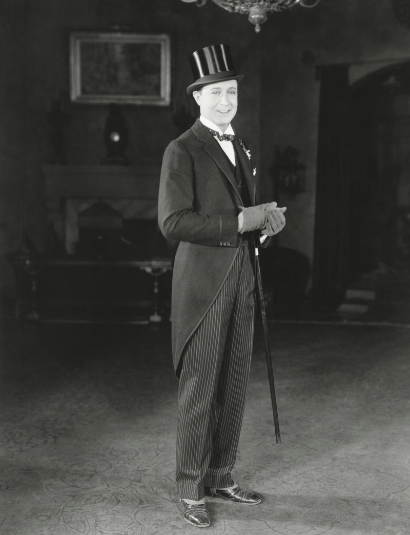 1920s Mens Fashion Formal Suit A groom on his wedding day wearing a formal morning suit look complete with a top hat and gloves.
