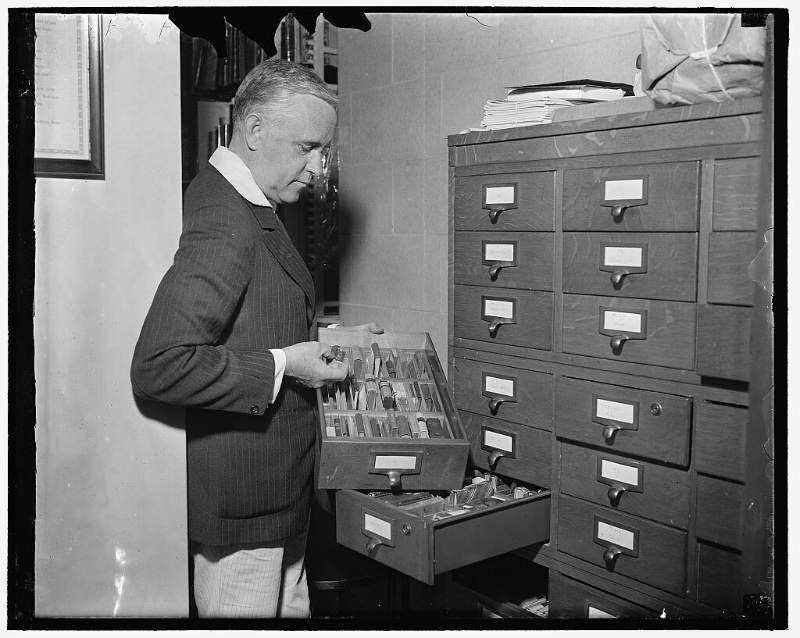 1930s Mens Fashion Man Pinstripe Suit Jacket Trousers Mix and Match 1937 Mixing a light and dark pinstripe suit jacket and pants, Library of Congress Rare Book Division curator V. Valtra Parma handles a collection of miniature books circa 1937.
