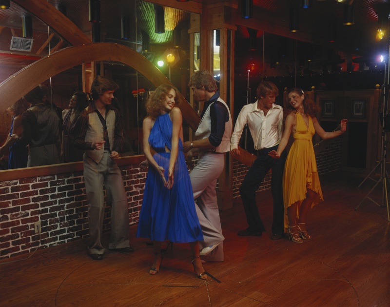 1970s Disco Style Couples Dancing Couples dance the night away in trendy 70s disco styles.