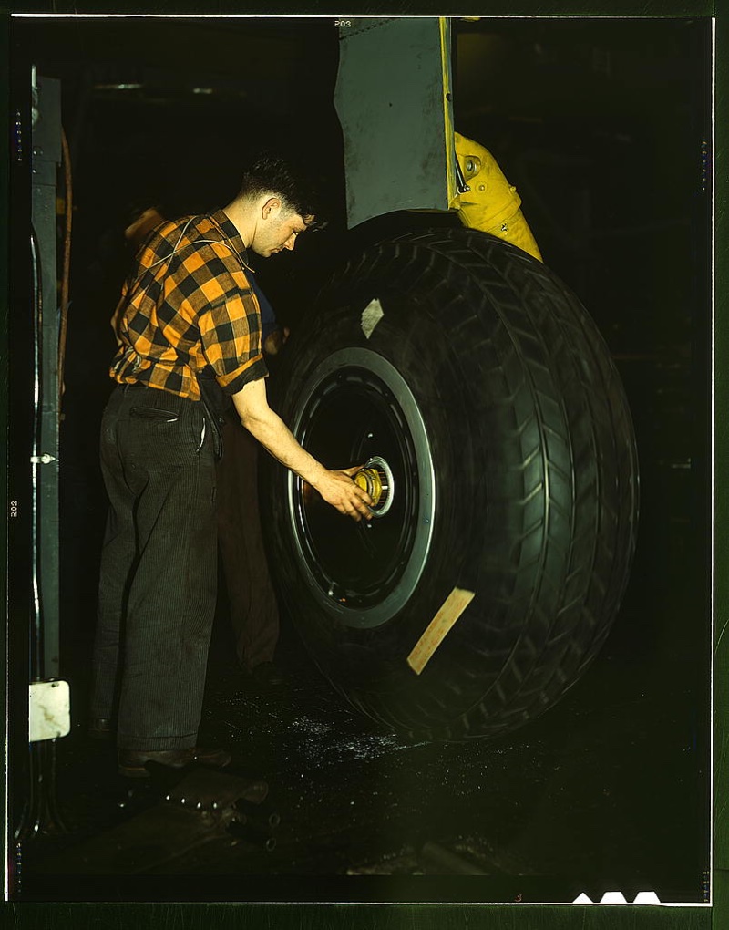 40s Fashion Men Check Shirt Sporting a check shirt, a worker inspects a landing wheel of the transport planes at Willow Run manufacturing plant in Michigan circa 1941-45.