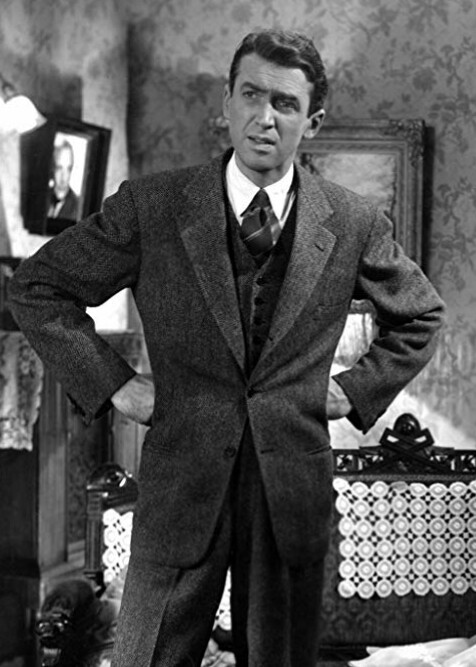 40s Fashion Men James Stewart Suit Its a Wonderful Life 1940s Men's Fashion: A still featuring James Stewart in It's a Wonderful Life (1946). Playing George Bailey, Stewart kept his style professional in a three-piece tweed suit.