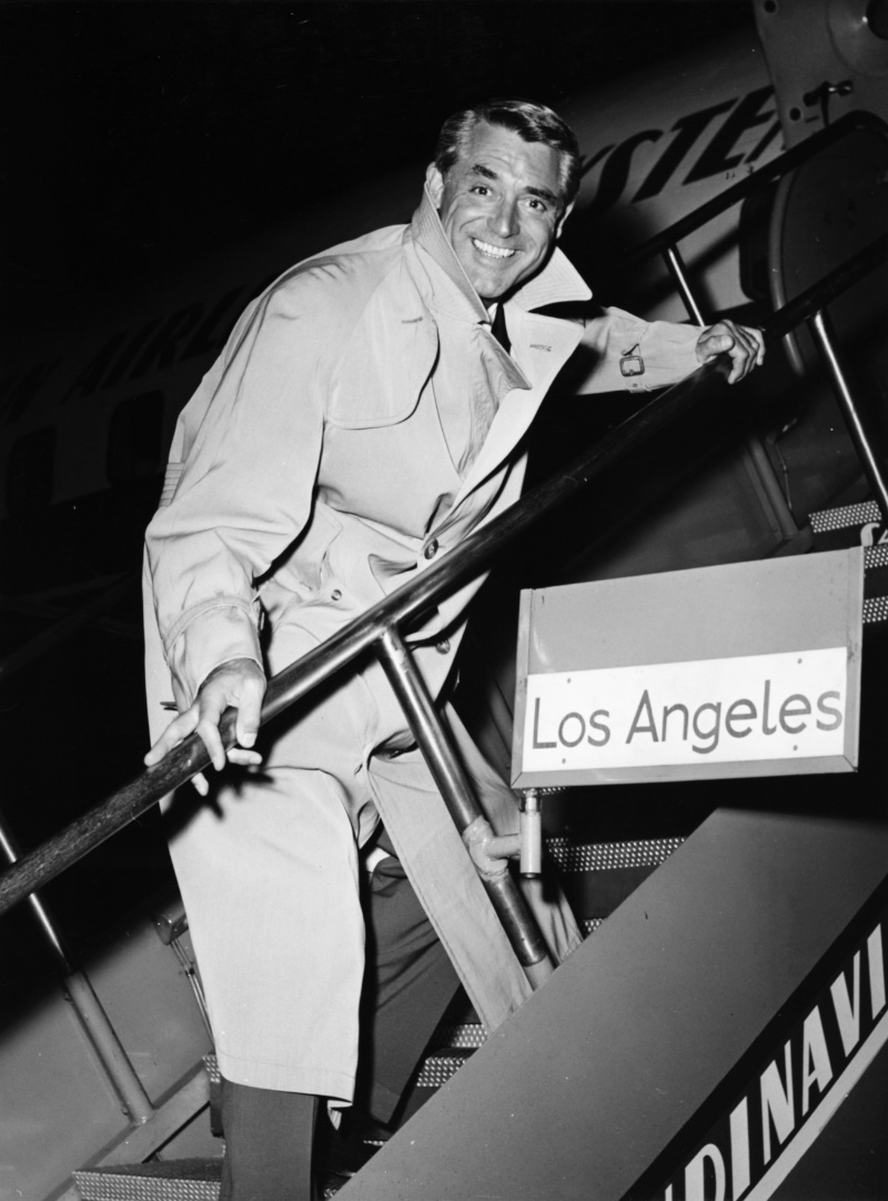50s Fashion Men Cary Grant Trench Cary Grant wears a classic trench at Kastrup Airport CPH in 1956.