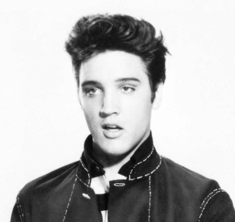 50s Fashion Men Elvis Presley High Collar Hair Elvis Presley appears in a 1957 image for Jailhouse Rock, wearing his signature upturned collar and pompadour hairstyle.