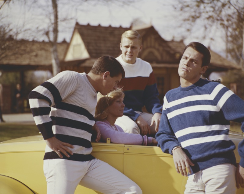 60s Fashion Men Striped Sweaters Young men wear striped sweaters evocative of sixties menswear trends.