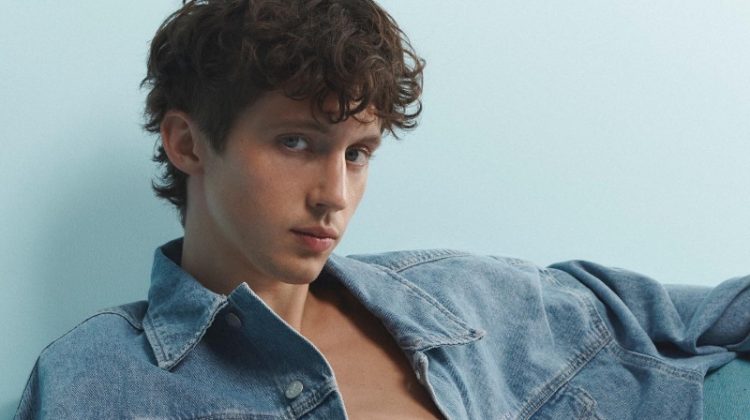 Troye Sivan sports a relaxed denim jean jacket with jeans for Calvin Klein's Pride campaign.