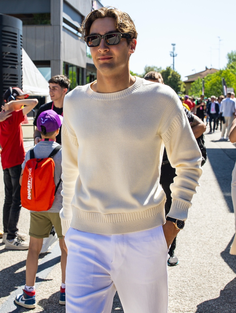 George Russell Tommy Hilfiger Imola Grand Prix 2024 001 George Russell is a chic vision in a sweater and white linen trousers at the Emilia Romagna Grand Prix.