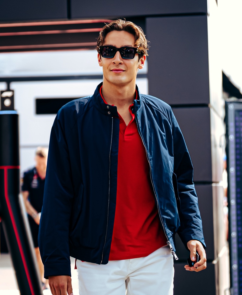 George Russell Tommy Hilfiger Imola Grand Prix 2024 002 Embracing classic sportswear, George Russell wears Tommy Hilfiger's Portland jacket with a red polo and white jeans at the Emilia Romagna Grand Prix.