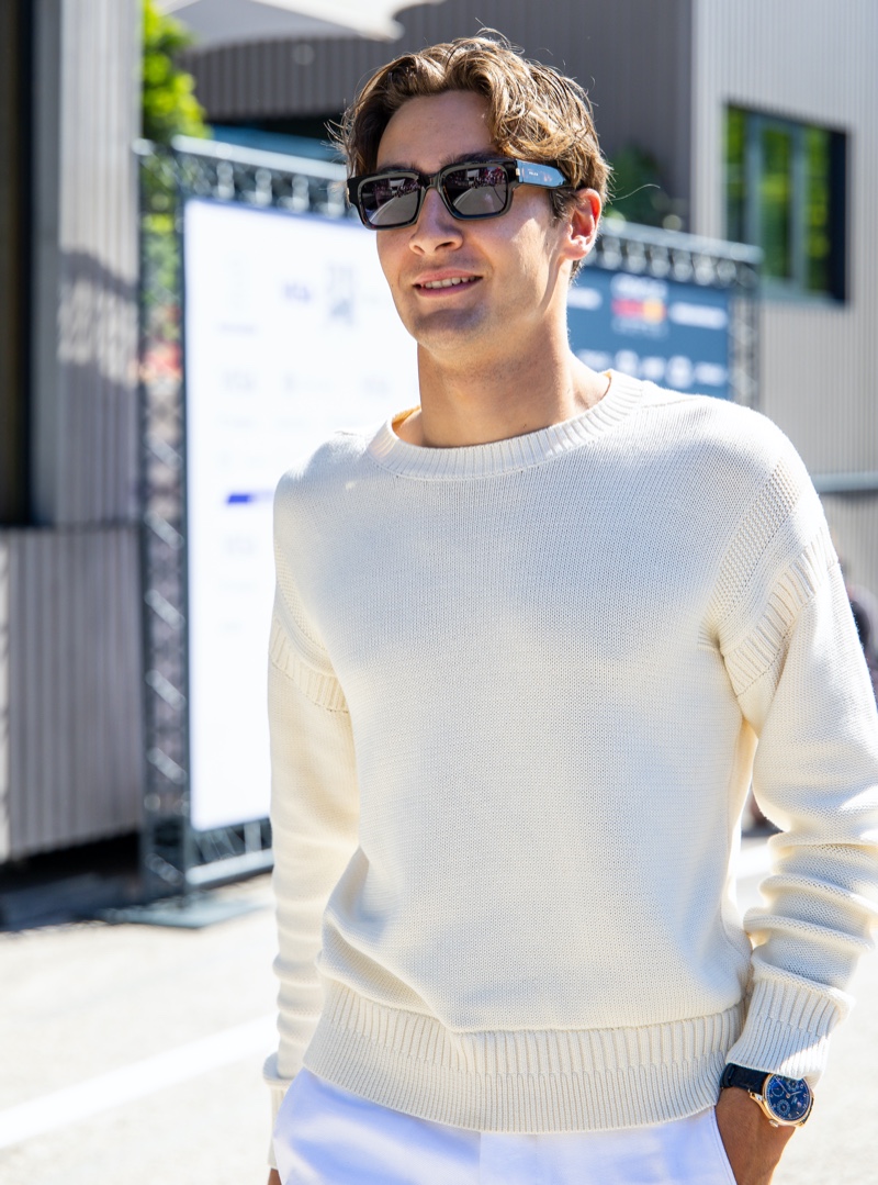 George Russell Tommy Hilfiger Imola Grand Prix 2024 003 George Russell sports a cream-colored sweater with linen trousers by Tommy Hilfiger at the Emilia Romagna Grand Prix.